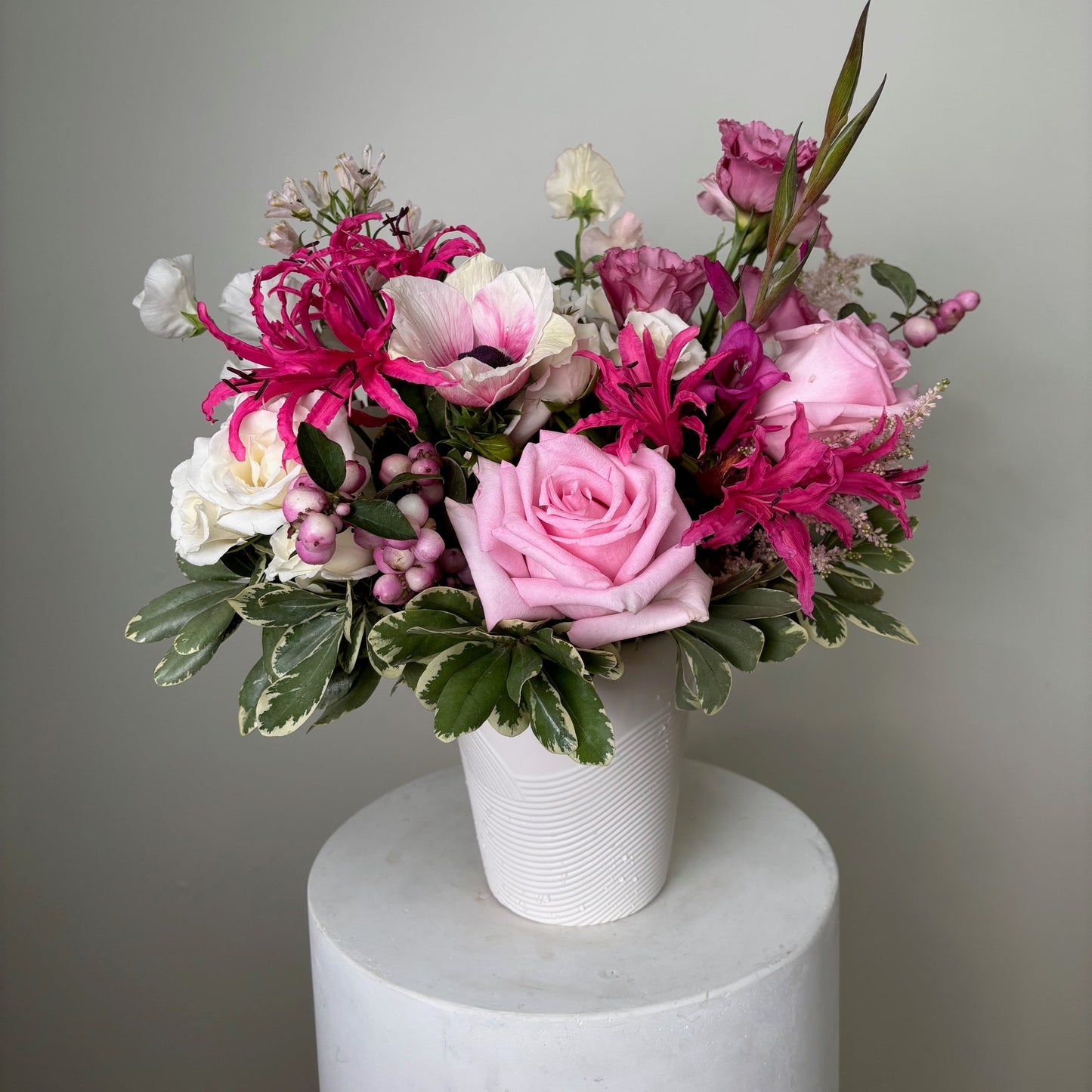 Bouquet of pink and white flowers on a gray background