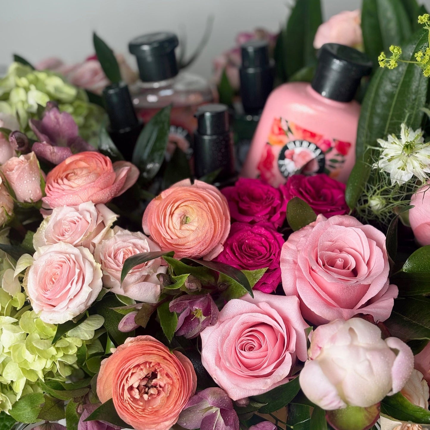 Bouquet of pink and green flowers with shampoo in the background