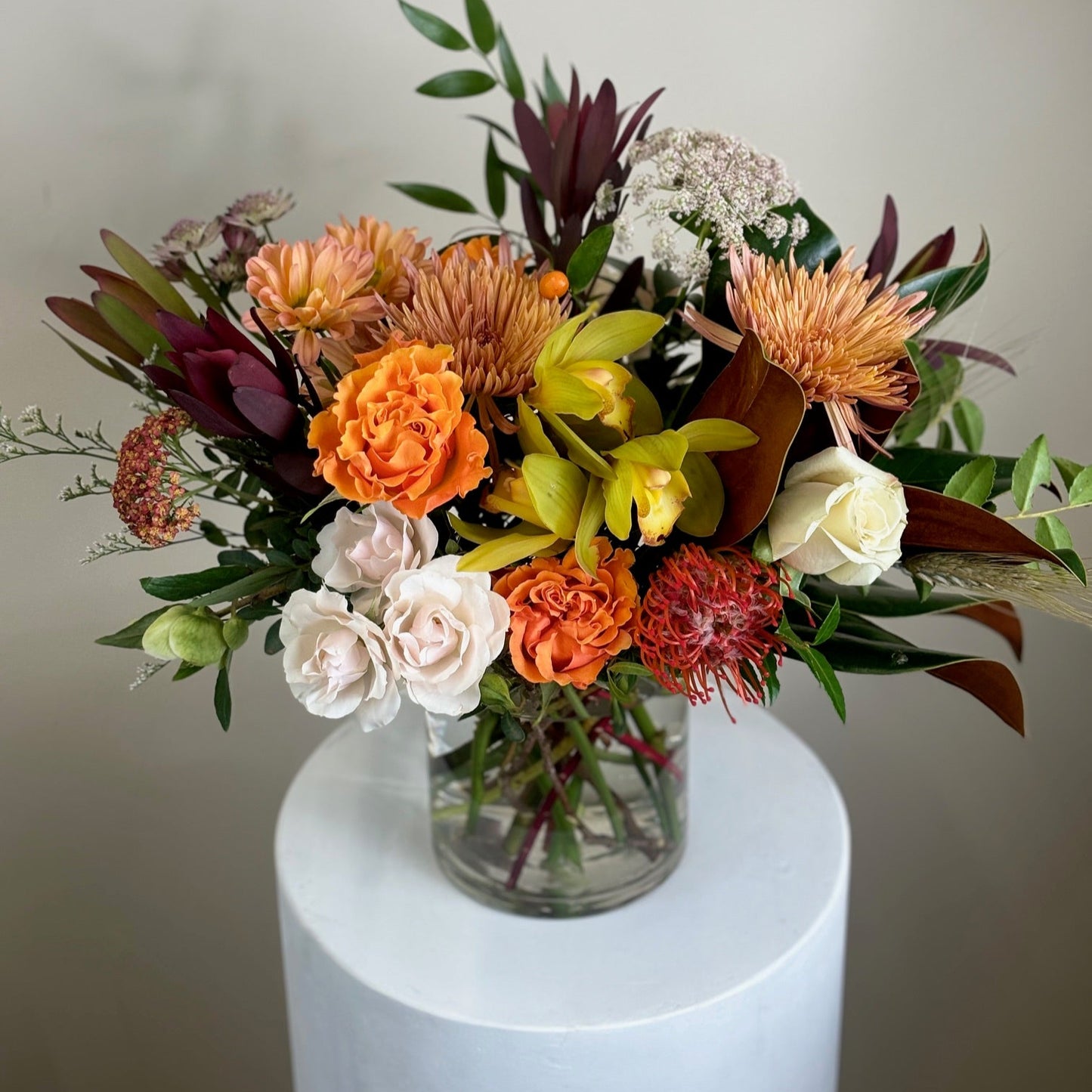 Orange yellow green flowers in a vase