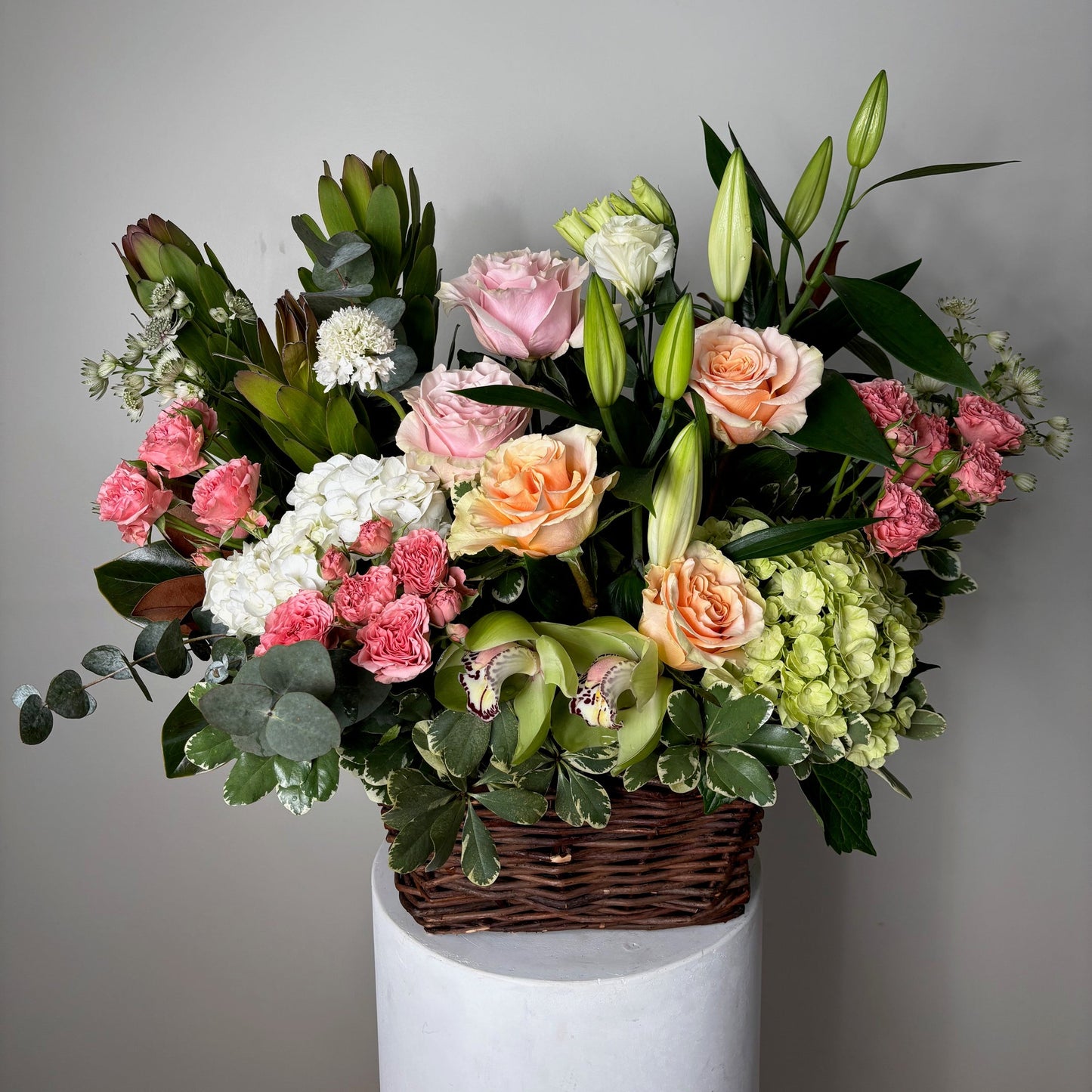 Bouquet of flowers in a white box with a gray background