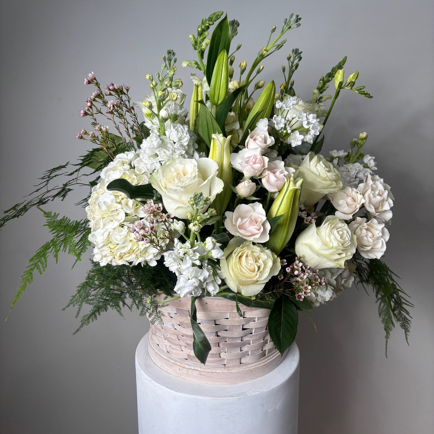Bouquet of flowers in a white box on a gray background